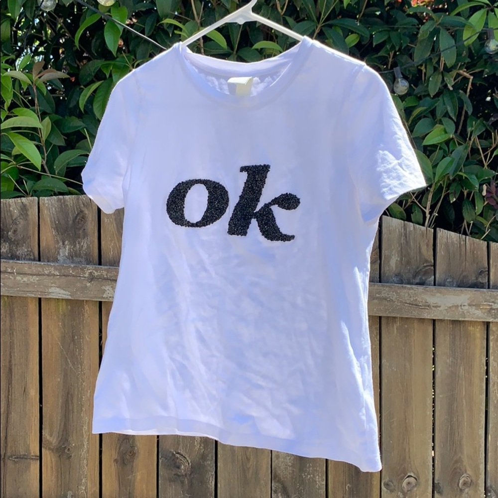 A black sequence OK white shirt